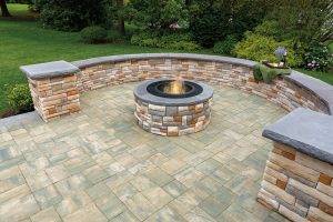 Patio with firepit, wall and pavers set in a random Installation 
